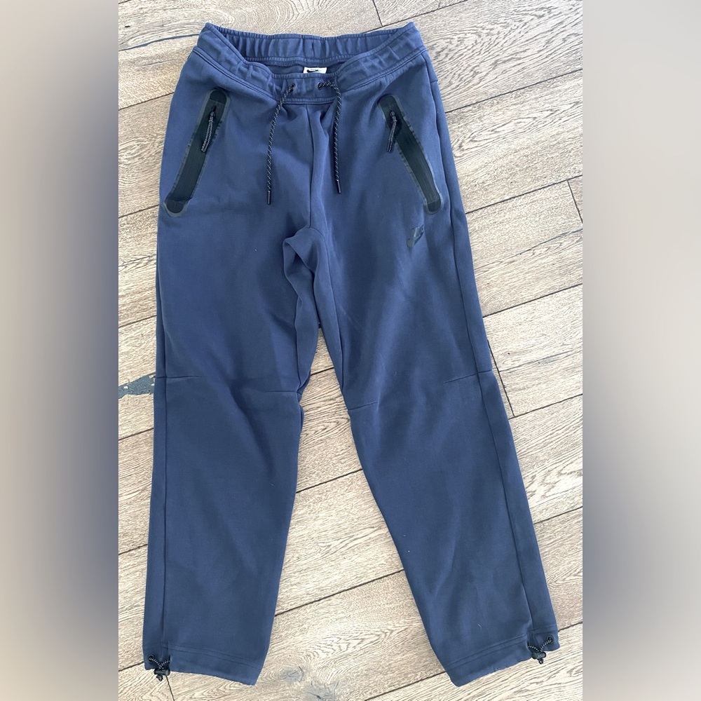 Navy blue Nike tech pants